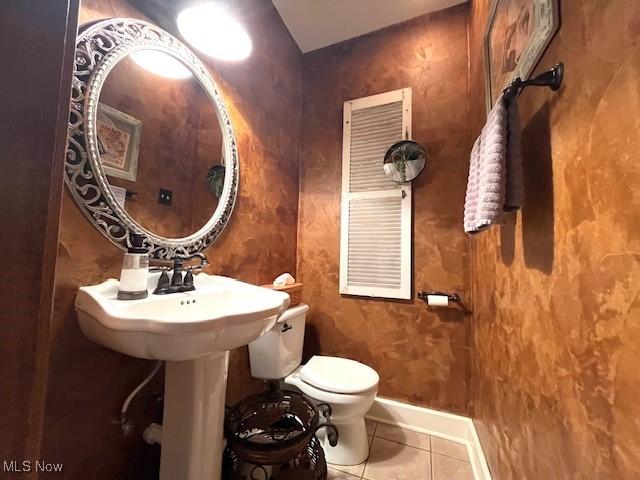 161 W Main St, New Concord, OH 43762 - half bathroom featuring tile patterned flooring, toilet, and baseboards