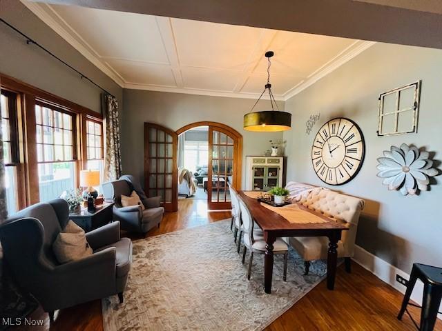 161 W Main St, New Concord, OH 43762 - dining area with wood finished floors, arched walkways, crown molding, and baseboards