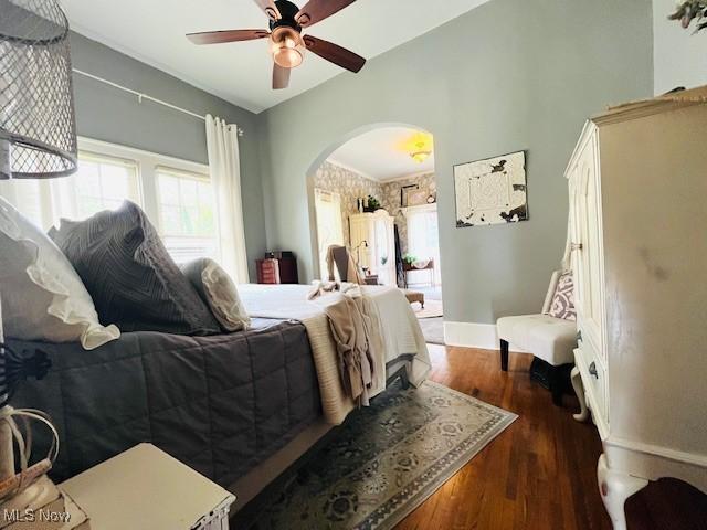 161 W Main St, New Concord, OH 43762 - bedroom with arched walkways, multiple windows, wood finished floors, and baseboards