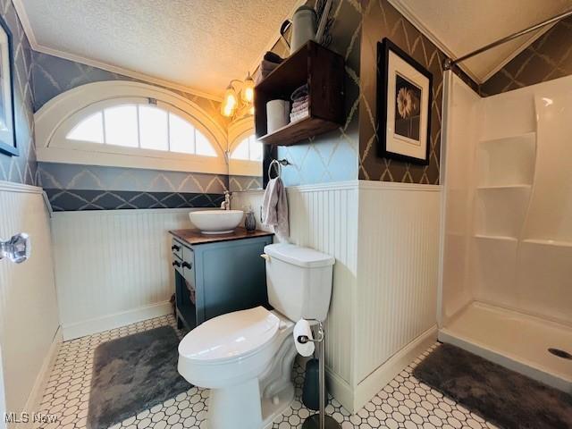 161 W Main St, New Concord, OH 43762 - full bathroom with vanity, crown molding, toilet, a shower, and baseboards