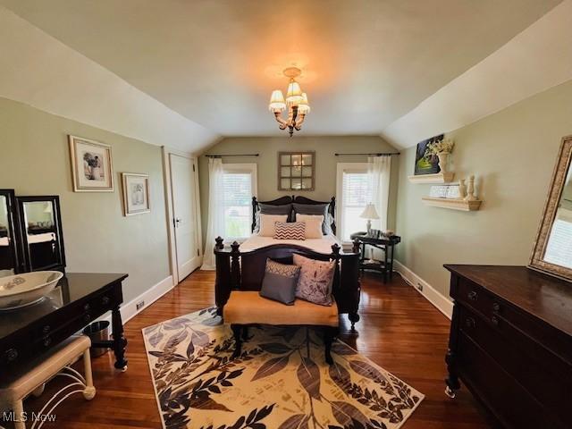 161 W Main St, New Concord, OH 43762 - bedroom with lofted ceiling, baseboards, a chandelier, and dark wood finished floors