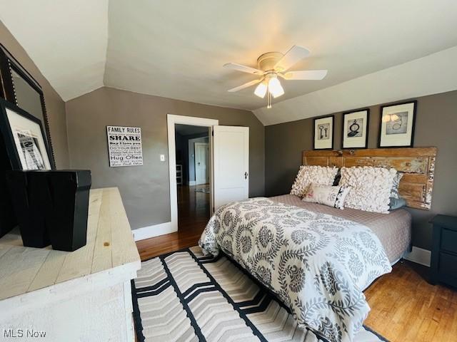 161 W Main St, New Concord, OH 43762 - bedroom featuring lofted ceiling, wood finished floors, baseboards, and a ceiling fan