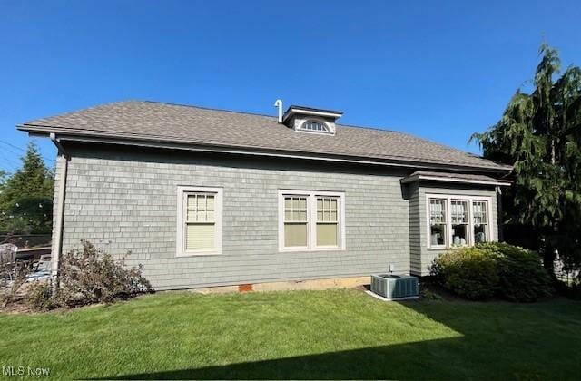 161 W Main St, New Concord, OH 43762 - rear view of property featuring a lawn and central AC