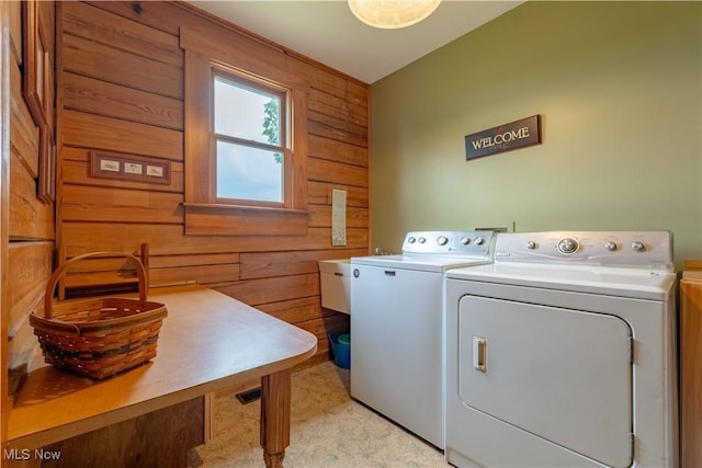 6165 Tyro St NE, Louisville, OH 44641 - laundry room with wood walls and washing machine and clothes dryer