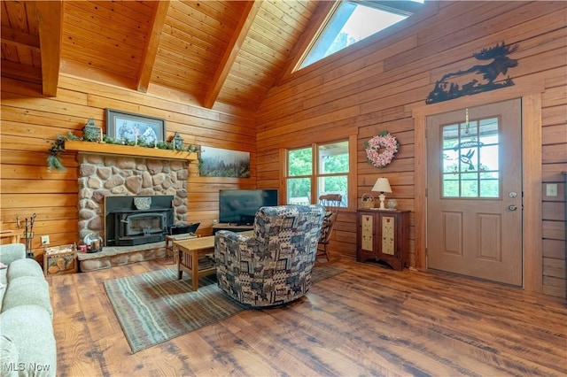 6165 Tyro St NE, Louisville, OH 44641 - living room featuring wood finished floors, wood walls, wood ceiling, and a wood stove