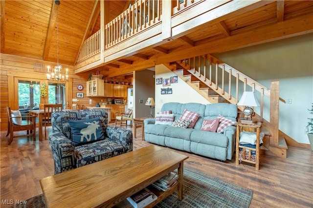 6165 Tyro St NE, Louisville, OH 44641 - living area with a chandelier, wooden ceiling with exposed beams, wood walls, wood finished floors, and stairway