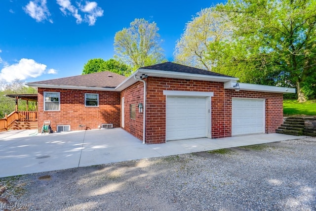 396 2nd St NE, Carrollton, OH 44615 - view of property exterior with brick siding, driveway, roof with shingles, and a garage