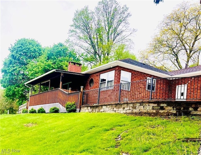396 2nd St NE, Carrollton, OH 44615 - view of home's exterior featuring a chimney and a lawn