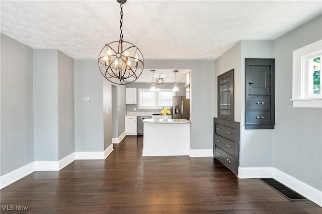 990 Franklin Ave, Salem, OH 44460 - kitchen with appliances with stainless steel finishes, a chandelier, dark wood-style flooring, white cabinets, and baseboards