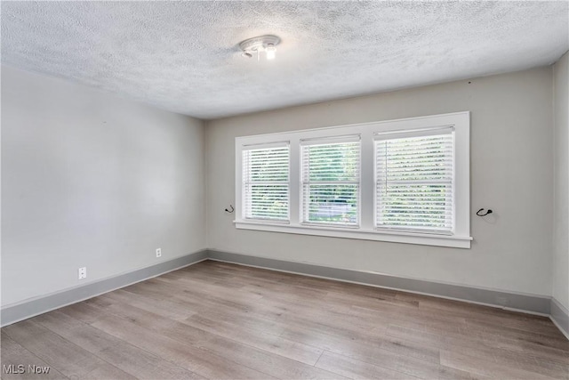 990 Franklin Ave, Salem, OH 44460 - empty room with a textured ceiling, wood finished floors, and baseboards
