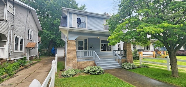816 Clarendon Ave NW, Canton, OH 44708 - american foursquare style home with a porch, a front lawn, a garage, and brick siding