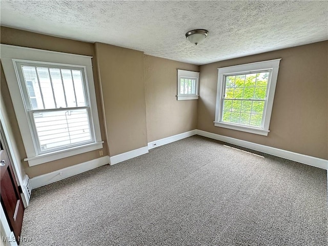 816 Clarendon Ave NW, Canton, OH 44708 - unfurnished room with baseboards, carpet flooring, and a textured ceiling