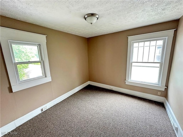 816 Clarendon Ave NW, Canton, OH 44708 - carpeted spare room featuring baseboards and a textured ceiling