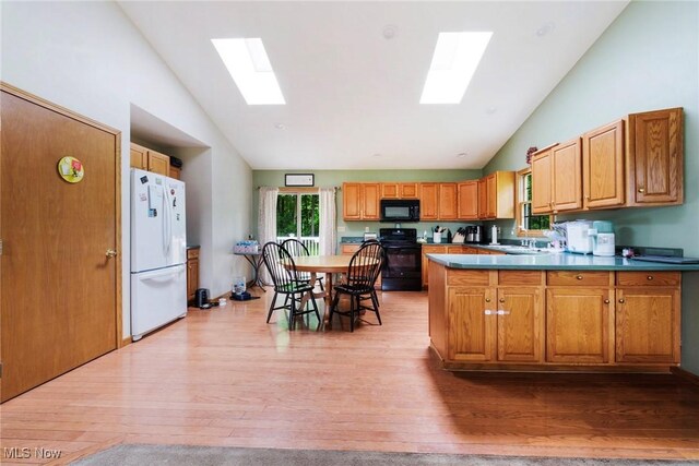 51406 Cornerstone Dr, Petersburg, OH 44454 - kitchen with black appliances, a skylight, high vaulted ceiling, a peninsula, and light wood-type flooring