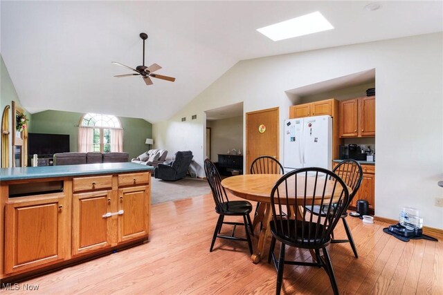 51406 Cornerstone Dr, Petersburg, OH 44454 - dining space featuring vaulted ceiling, light wood-style floors, a ceiling fan, and a skylight