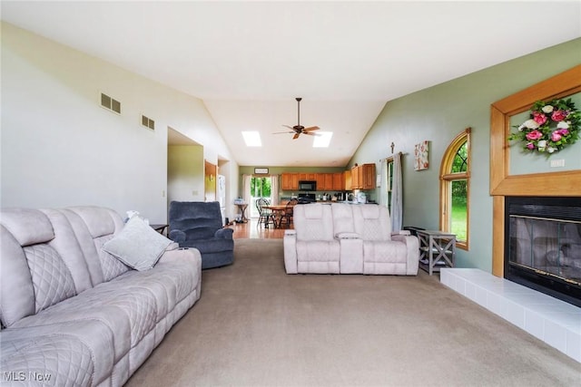 51406 Cornerstone Dr, Petersburg, OH 44454 - living area featuring ceiling fan, a tiled fireplace, lofted ceiling, and light carpet