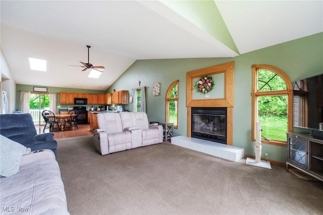 51406 Cornerstone Dr, Petersburg, OH 44454 - carpeted living area with vaulted ceiling, a glass covered fireplace, and ceiling fan