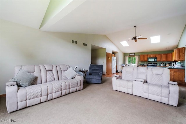 51406 Cornerstone Dr, Petersburg, OH 44454 - living area featuring a skylight, light colored carpet, high vaulted ceiling, and ceiling fan