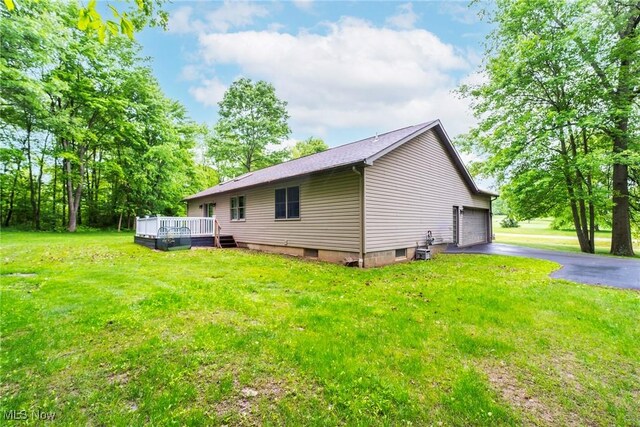 51406 Cornerstone Dr, Petersburg, OH 44454 - view of home's exterior with a deck, a lawn, a garage, and asphalt driveway