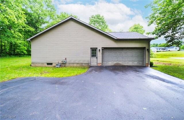 51406 Cornerstone Dr, Petersburg, OH 44454 - view of side of home with driveway, an attached garage, and a yard