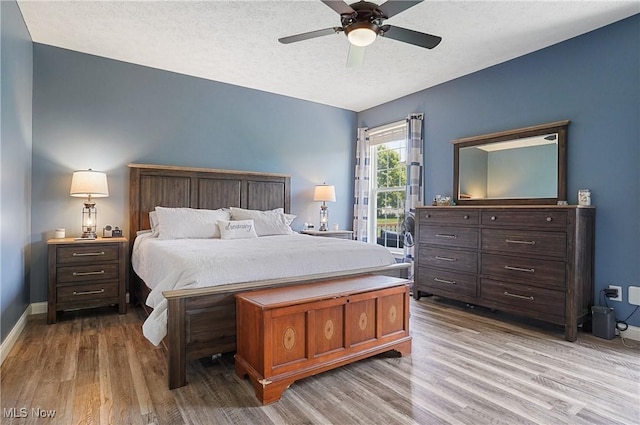 269 Brookledge Ln, Copley, OH 44321 - bedroom featuring wood finished floors, baseboards, a textured ceiling, and a ceiling fan