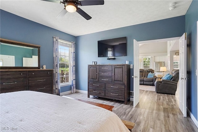 269 Brookledge Ln, Copley, OH 44321 - bedroom featuring wood finished floors, baseboards, multiple windows, and a ceiling fan