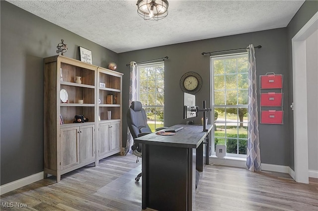 269 Brookledge Ln, Copley, OH 44321 - home office with light wood-type flooring, healthy amount of natural light, baseboards, and a textured ceiling