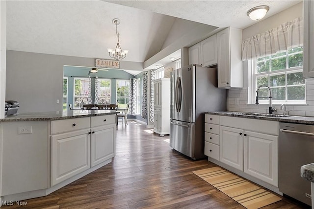 269 Brookledge Ln, Copley, OH 44321 - kitchen featuring stainless steel appliances, a sink, a chandelier, dark wood-style flooring, and vaulted ceiling