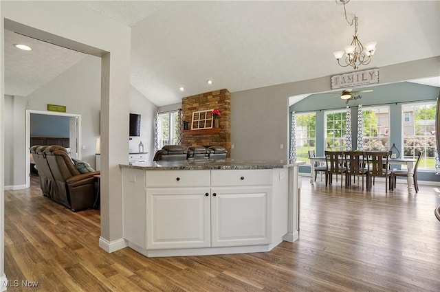 269 Brookledge Ln, Copley, OH 44321 - kitchen featuring open floor plan, lofted ceiling, wood finished floors, white cabinets, and a ceiling fan