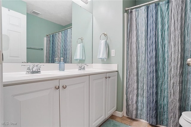 269 Brookledge Ln, Copley, OH 44321 - full bath with double vanity, tile patterned flooring, curtained shower, and toilet