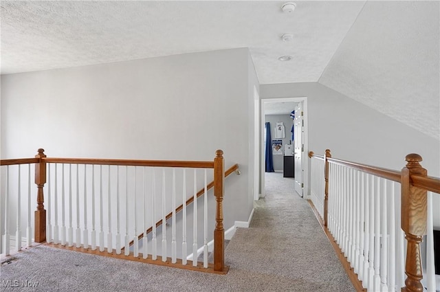 269 Brookledge Ln, Copley, OH 44321 - hall with an upstairs landing, carpet floors, a textured ceiling, lofted ceiling, and baseboards