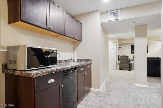 269 Brookledge Ln, Copley, OH 44321 - kitchen with stainless steel microwave, black dishwasher, light colored carpet, dark brown cabinetry, and a sink