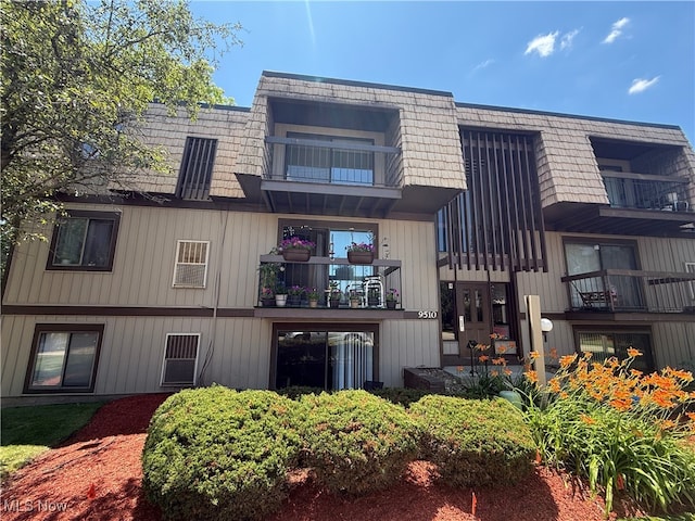 9510 Cove Dr Unit C9, North Royalton, OH 44133 - back of house featuring a balcony and mansard roof