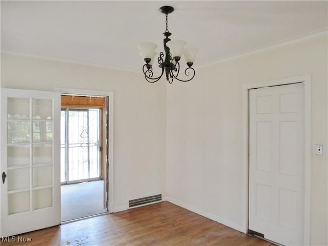 3659 Riedham Rd, Shaker Heights, OH 44120 - unfurnished dining area with a chandelier, ornamental molding, wood finished floors, and baseboards