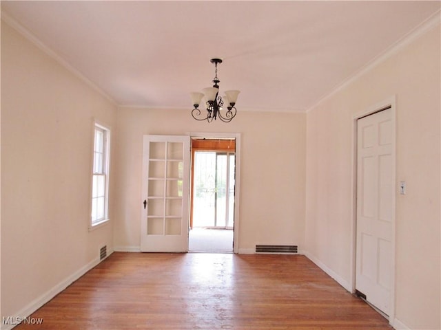 3659 Riedham Rd, Shaker Heights, OH 44120 - spare room featuring a chandelier, plenty of natural light, ornamental molding, and wood finished floors