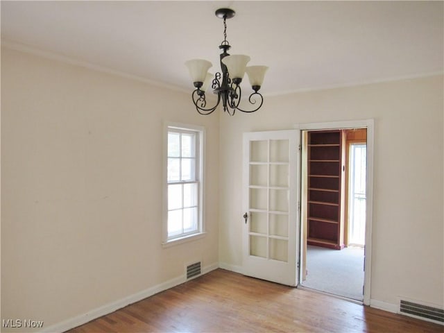 3659 Riedham Rd, Shaker Heights, OH 44120 - spare room featuring wood finished floors, crown molding, a chandelier, and baseboards