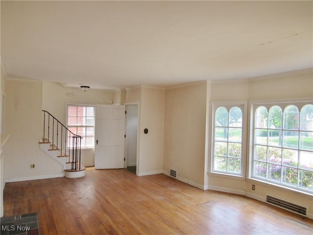 3659 Riedham Rd, Shaker Heights, OH 44120 - unfurnished room with light wood-type flooring, stairs, baseboards, and crown molding