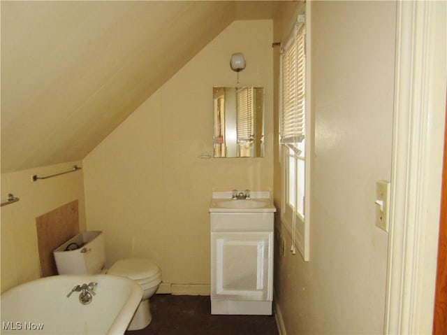 3659 Riedham Rd, Shaker Heights, OH 44120 - bathroom with a soaking tub, vanity, vaulted ceiling, toilet, and baseboards