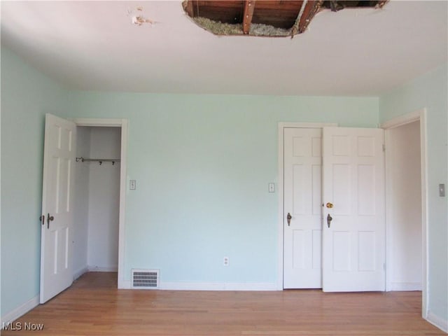 3659 Riedham Rd, Shaker Heights, OH 44120 - unfurnished bedroom featuring wood finished floors, baseboards, and a spacious closet