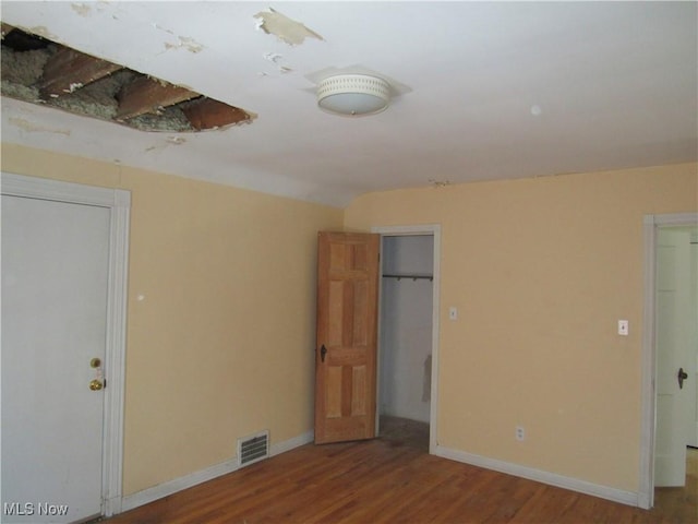 3659 Riedham Rd, Shaker Heights, OH 44120 - unfurnished bedroom with wood finished floors, baseboards, and a spacious closet