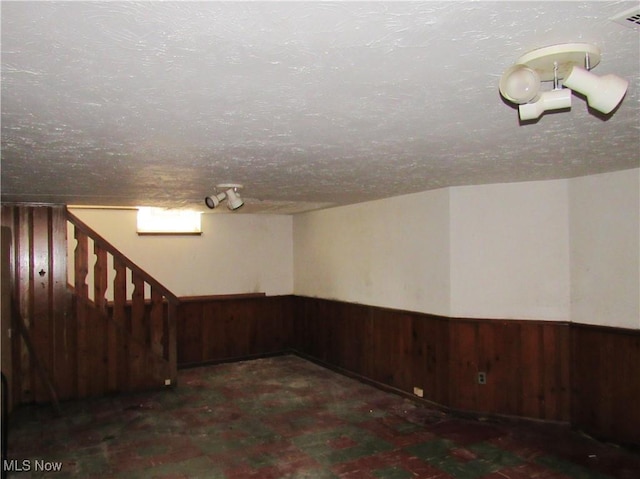 3659 Riedham Rd, Shaker Heights, OH 44120 - finished below grade area featuring wood walls, wainscoting, a textured ceiling, and stairs