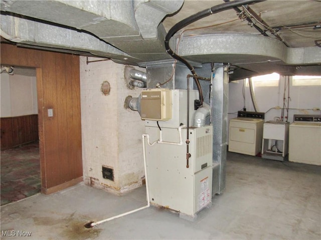 3659 Riedham Rd, Shaker Heights, OH 44120 - basement featuring washer / clothes dryer, a sink, wood walls, and heating unit