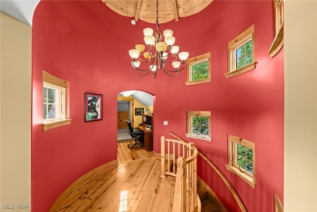 1350 Bell Rd, Chagrin Falls, OH 44022 - dining space with a high ceiling, arched walkways, wood-type flooring, a chandelier, and an office area