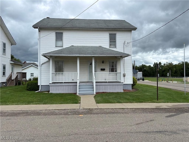 181 5th St NE, Carrollton, OH 44615 - view of front of home with a porch, a front lawn, and a shingled roof