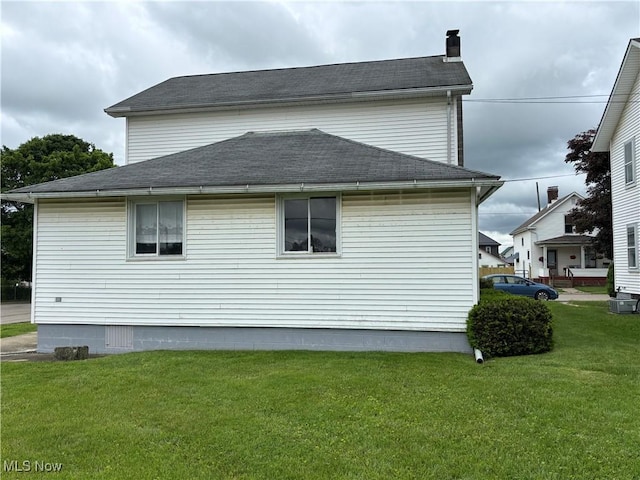 181 5th St NE, Carrollton, OH 44615 - view of property exterior featuring a yard, a chimney, and roof with shingles