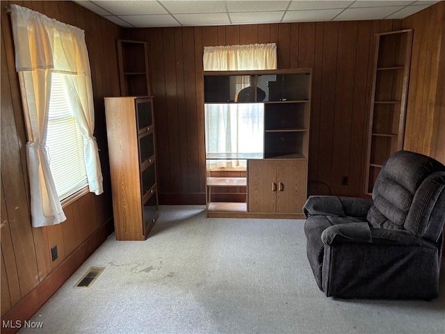 181 5th St NE, Carrollton, OH 44615 - living area with wood walls, a drop ceiling, and carpet flooring