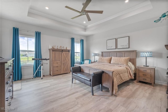34655 N Legends Way, Grafton, OH 44044 - bedroom featuring a raised ceiling, light wood-type flooring, multiple windows, and recessed lighting