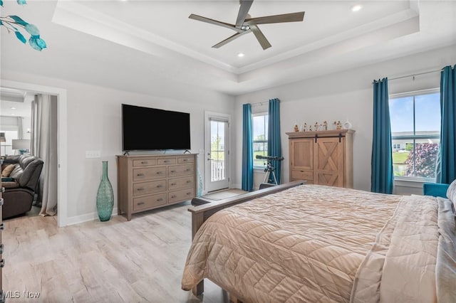 34655 N Legends Way, Grafton, OH 44044 - bedroom featuring a tray ceiling, multiple windows, access to exterior, light wood-style flooring, and recessed lighting