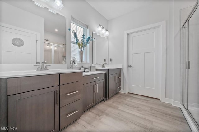 34655 N Legends Way, Grafton, OH 44044 - bathroom with a shower stall, double vanity, and wood finished floors