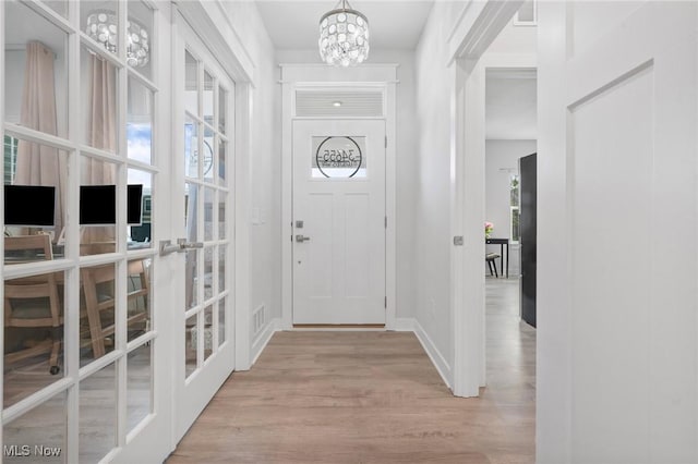 34655 N Legends Way, Grafton, OH 44044 - foyer entrance with wood finished floors, a chandelier, and french doors